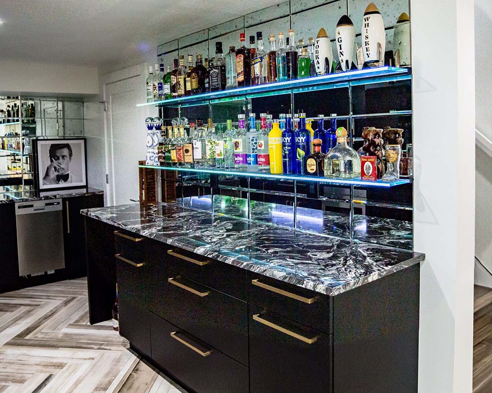 the old bathroom has been turned into a black and marble themed bar