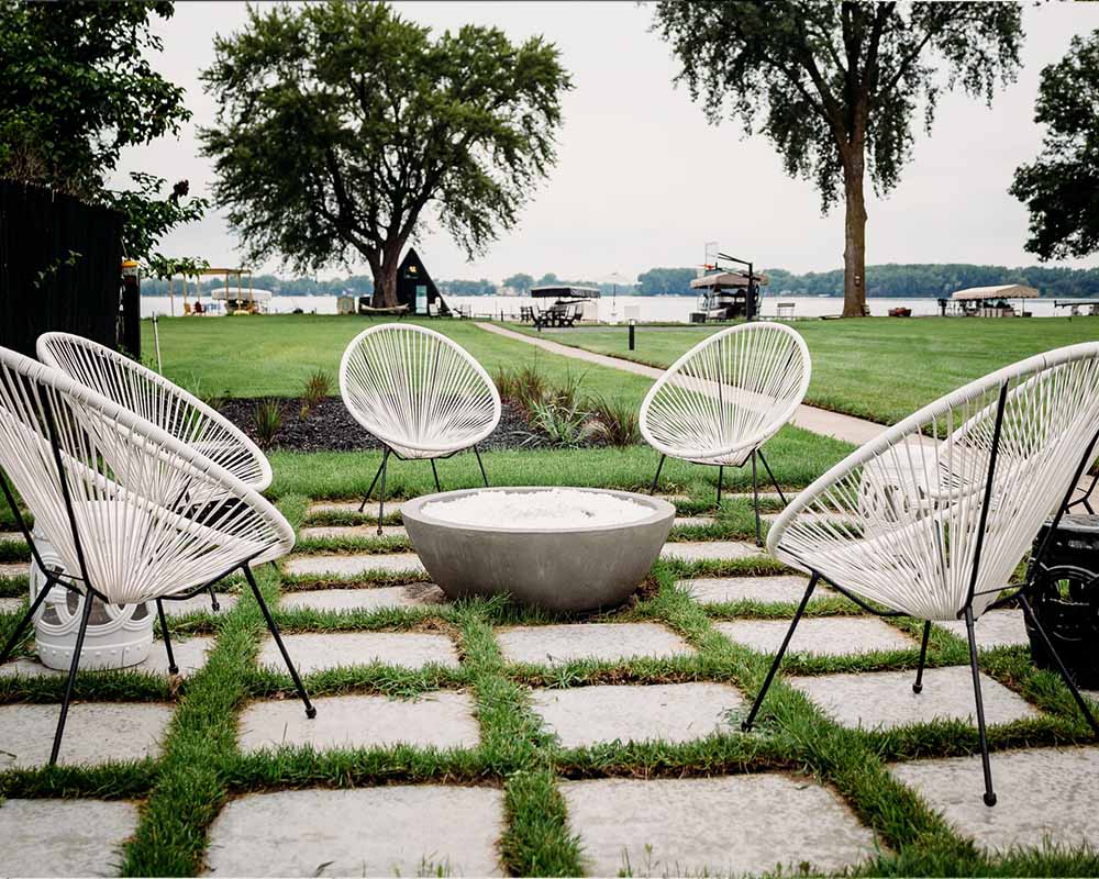 A fire pit area with chairs surrounding it