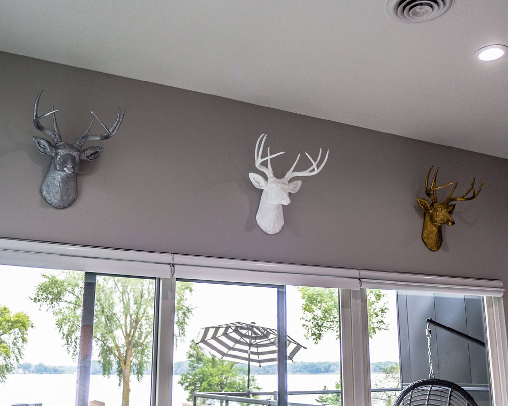 A bedroom painted fake deer head mounts