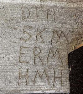 Initials carved into concrete