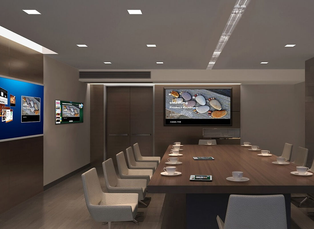 A modern business room with many screens on the walls
