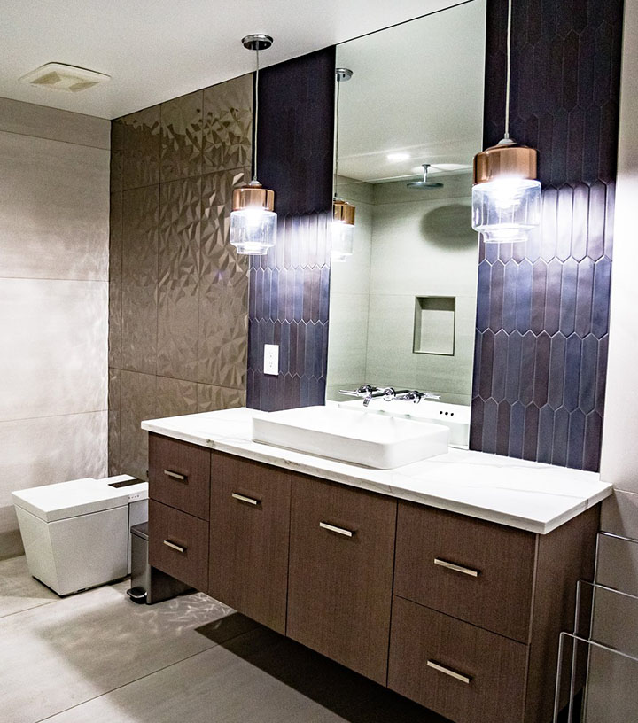 the updated bathroom with brown modern cabinets