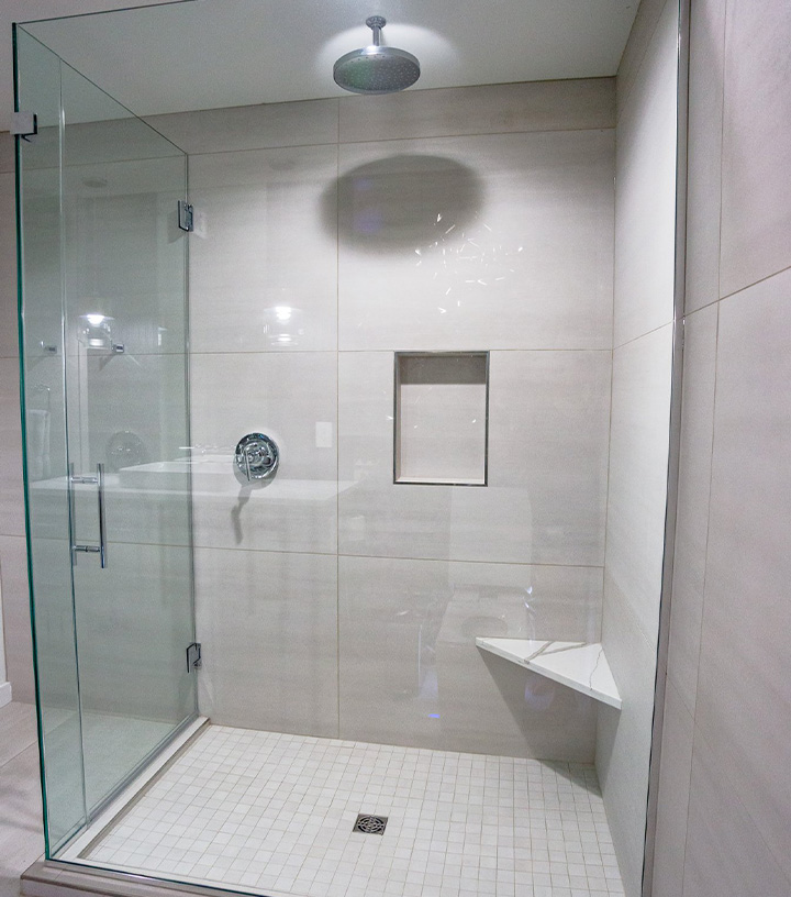 an updated bathroom with large white tiles