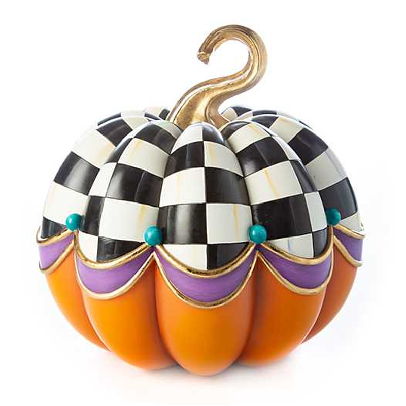 A fake pumpkin with black and white checker patterns