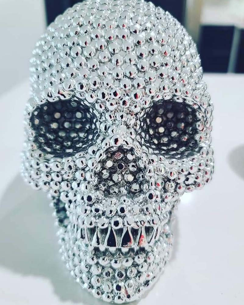 A fake skull with many shiny jewels all over it