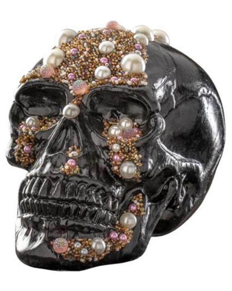 A fake black skull with pearls all over it