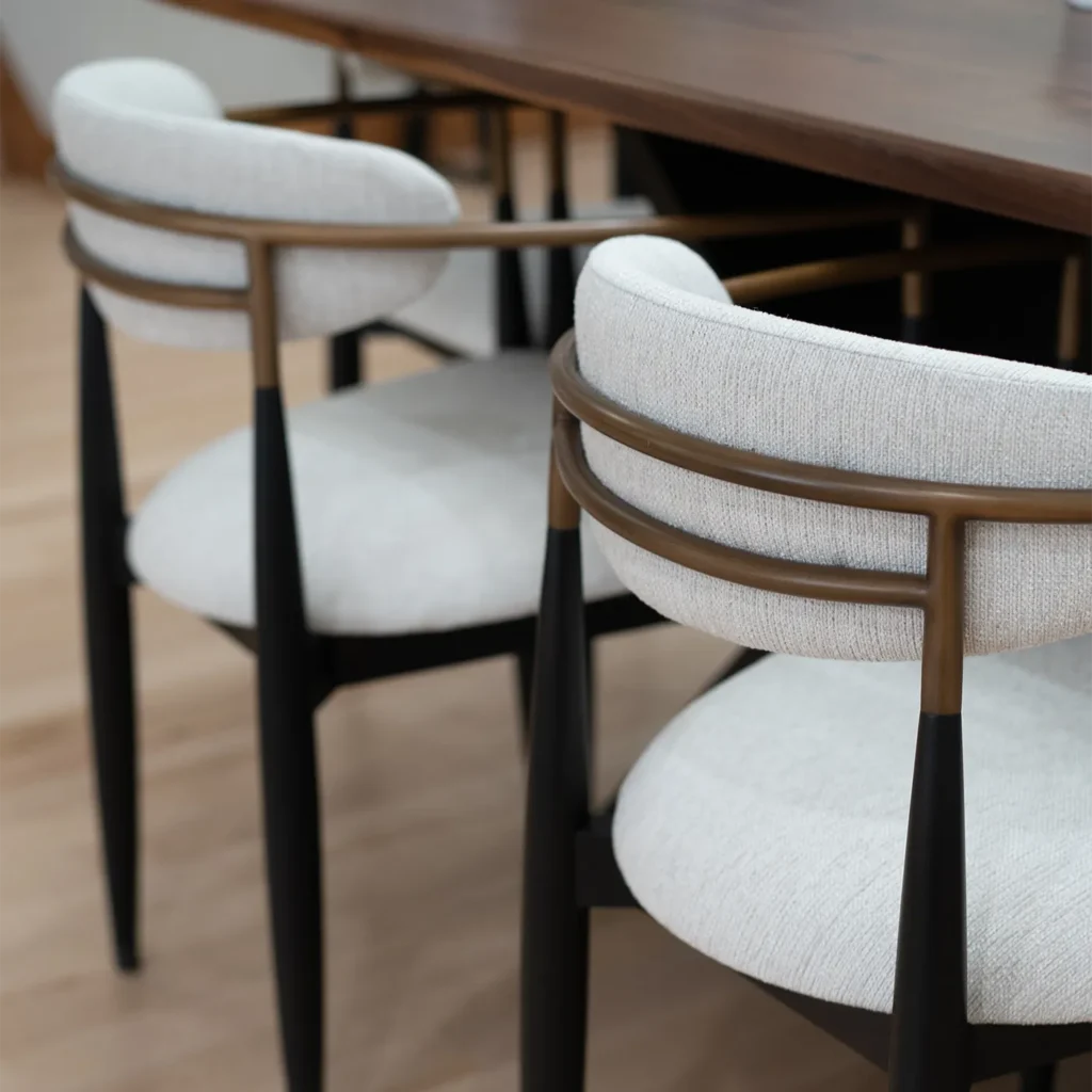 Modern upholstered dining chairs with dark wood table and light hardwood flooring