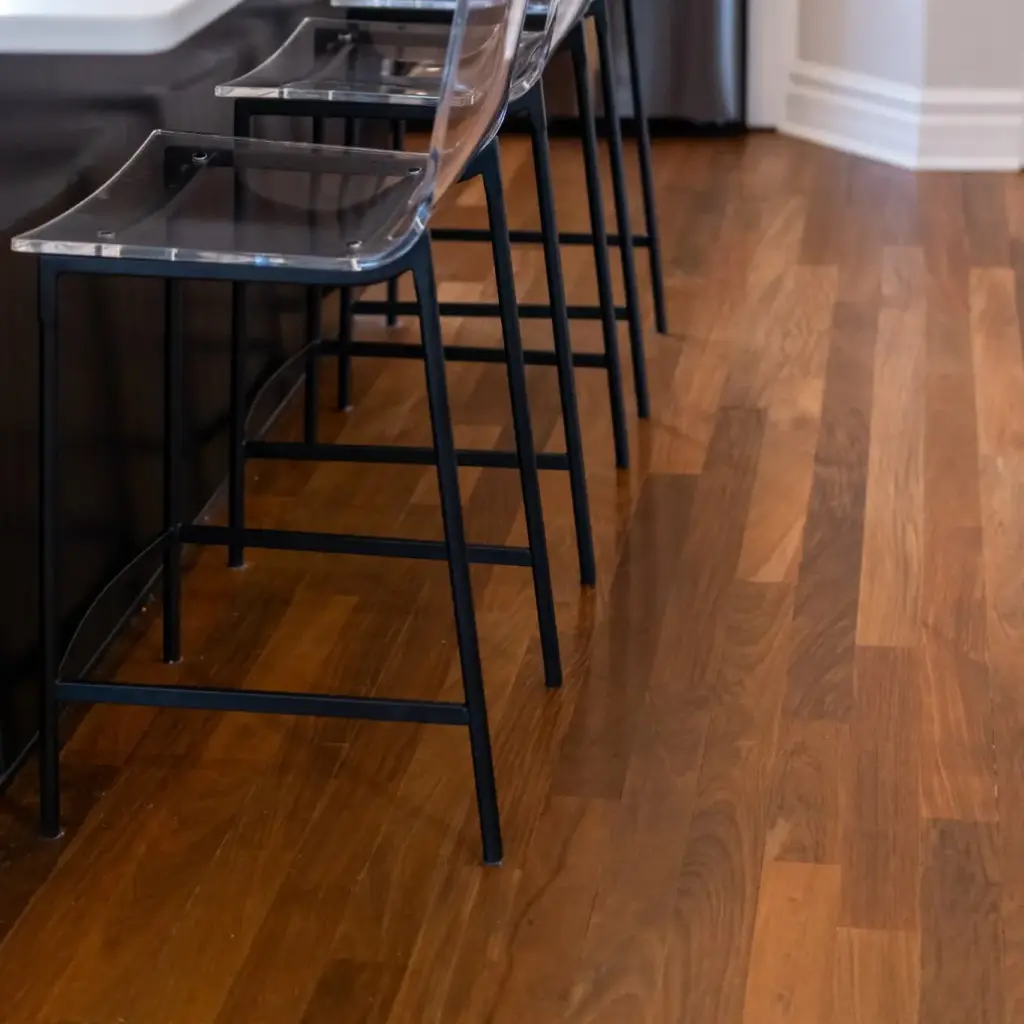 Modern kitchen island seating with transparent bar stools and rich hardwood flooring