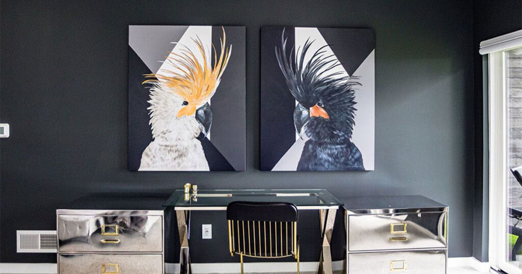 Modern black home office with mirrored desk, metallic accent cabinets, and bold bird artwork